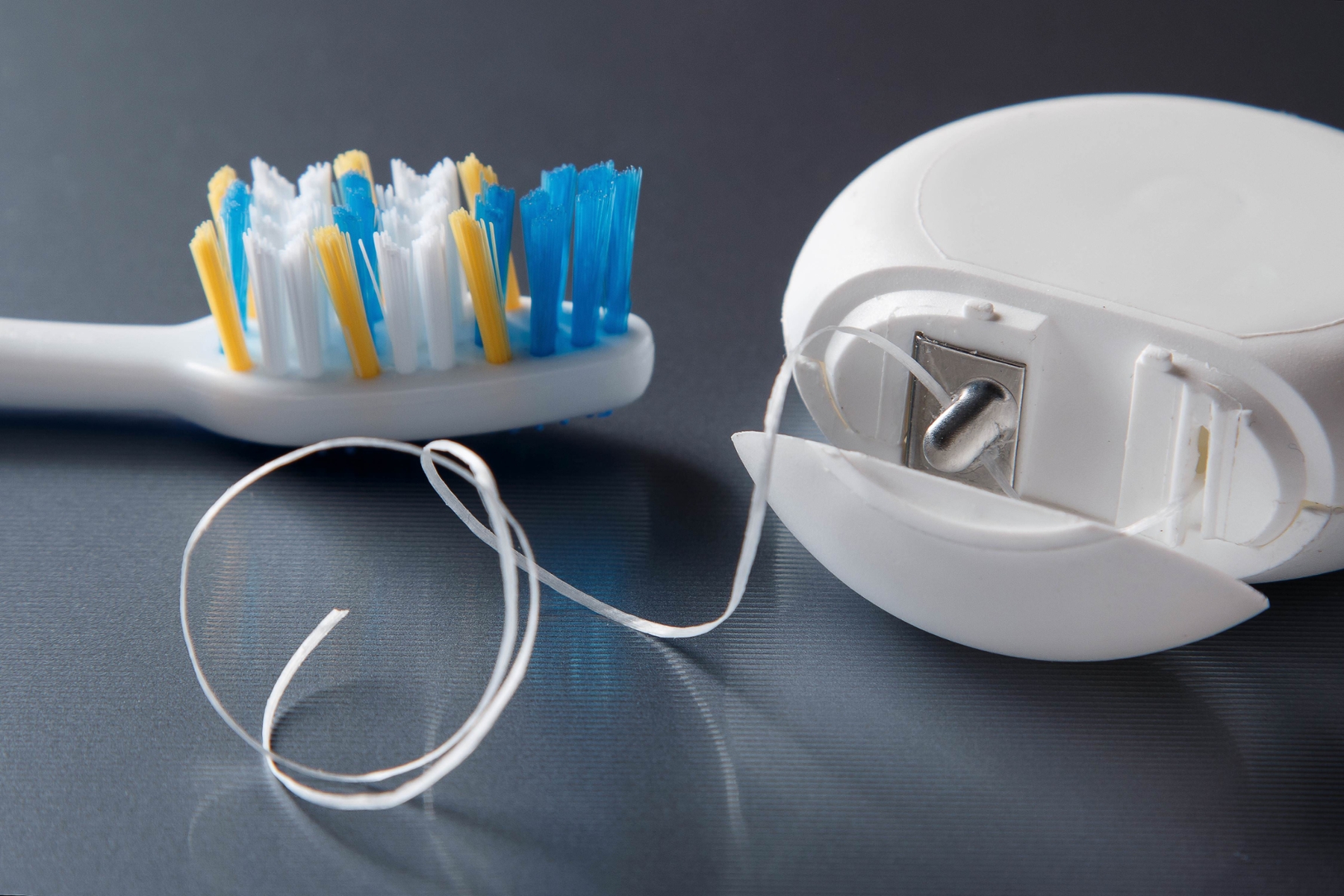 close up of dental floss and toothbrush at hall dental group in cookeville