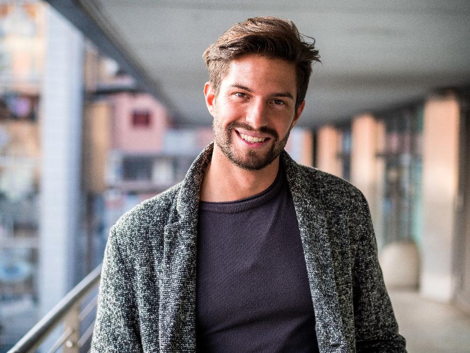 man in sweater smiling | dental implants cookeville tn