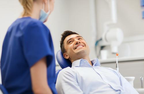 man sitting in dentist exam chair smiling | general dentistry cookeville tn