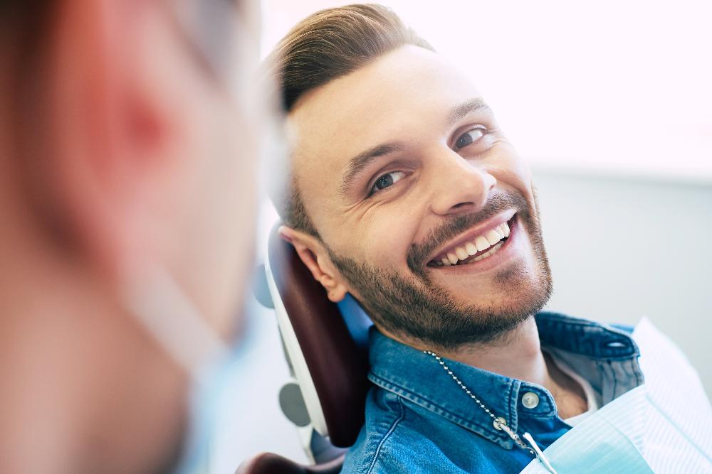 man smiling in exam chair | dental cookeville tn