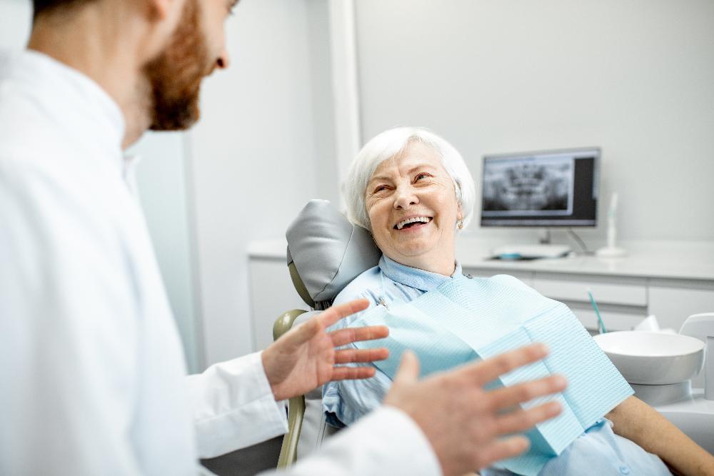 older woman sitting in dentist exam chair | cosmetic dentistry cookeville tn