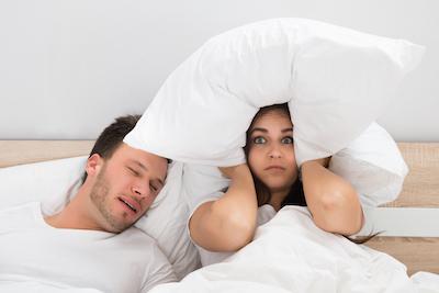 woman covering head with pillow | sleep apnea treatment cookeville tn