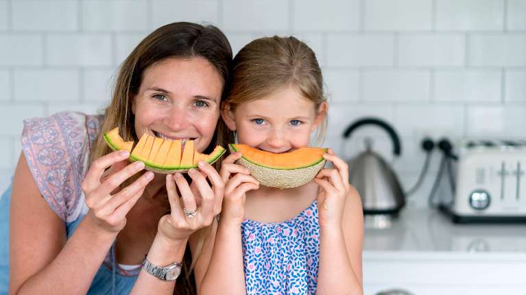 woman with daugher eating melon | dentist cookeville