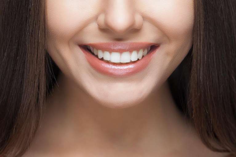 patient with brown hair smiling | clear aligner therapy cookeville tn