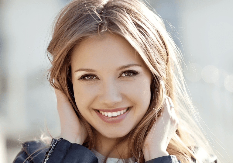 woman wearing jacket smiling | cosmetic dentist cookeville tn