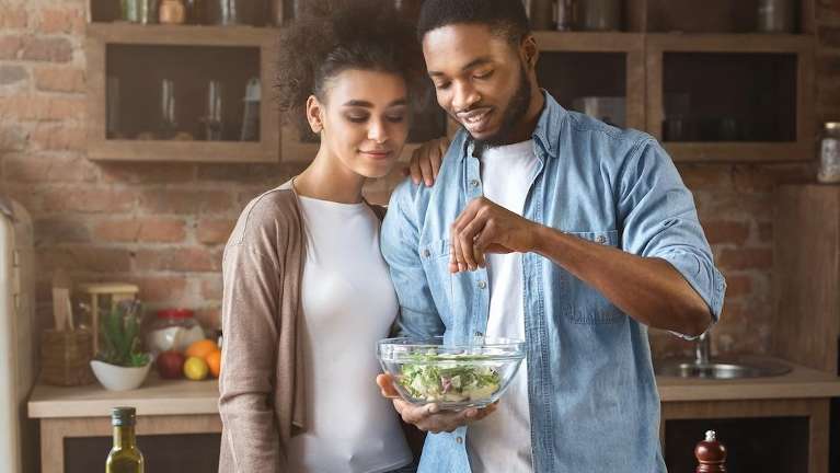 couple making salad | dental implants cookeville tn