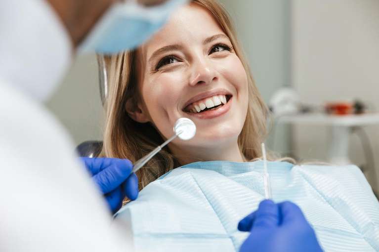 woman receiving dental exam in chair | sedation dentistry cookeville tn