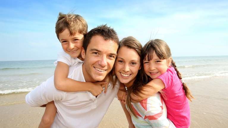 family of four on beach | dentist cookeville tn