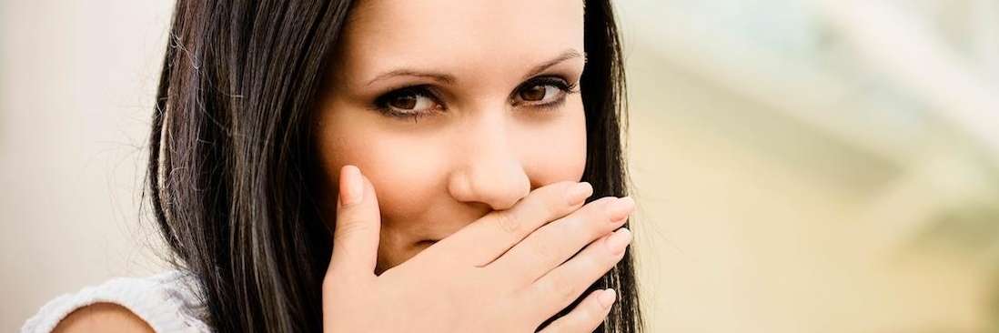 woman covering mouth with hand | dental cookeville tn