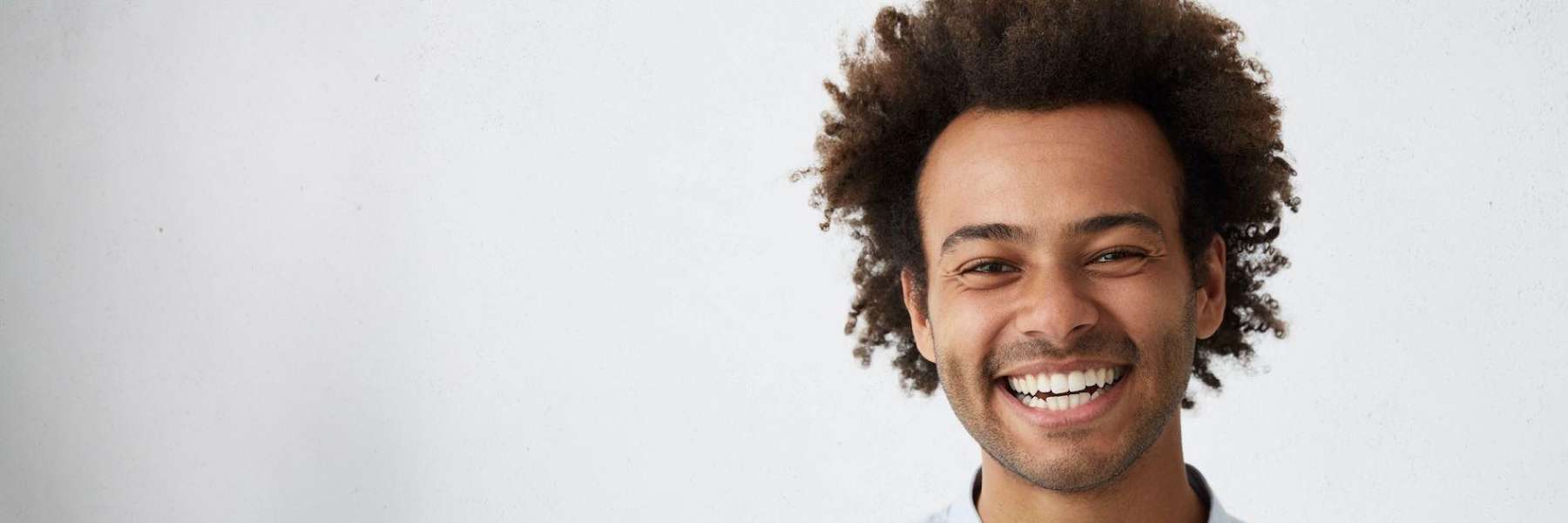 man with curly hair smiling | dental cookeville tn