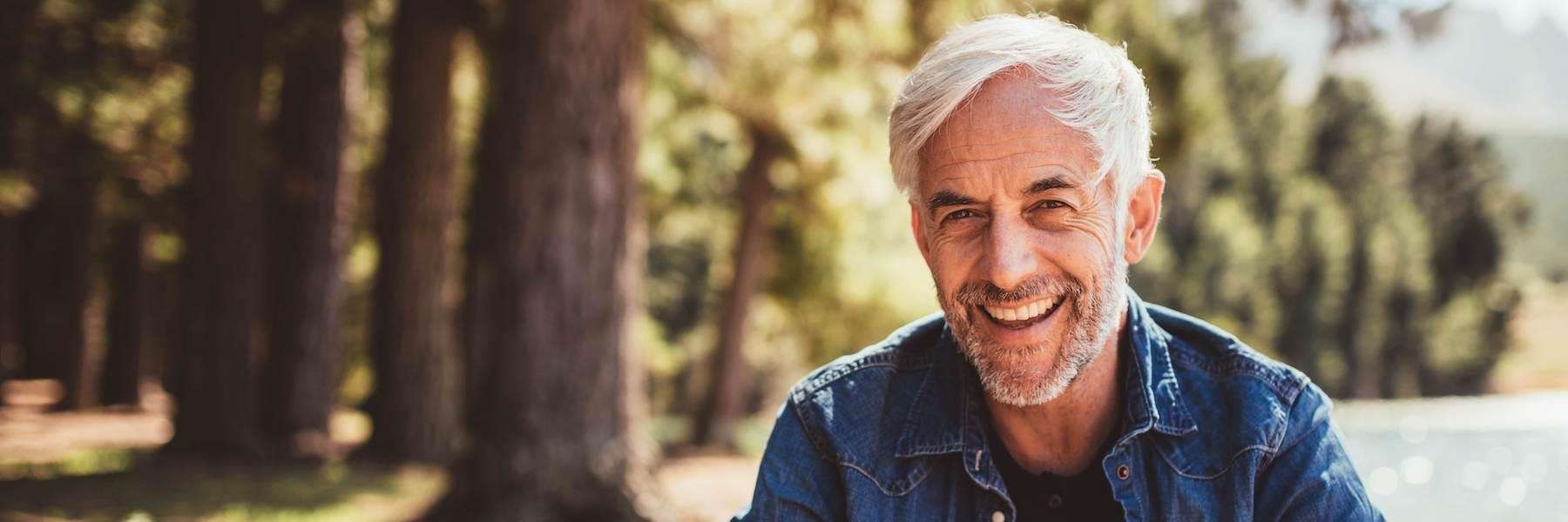 older man in blue shirt smiling | dental implants cookeville tn