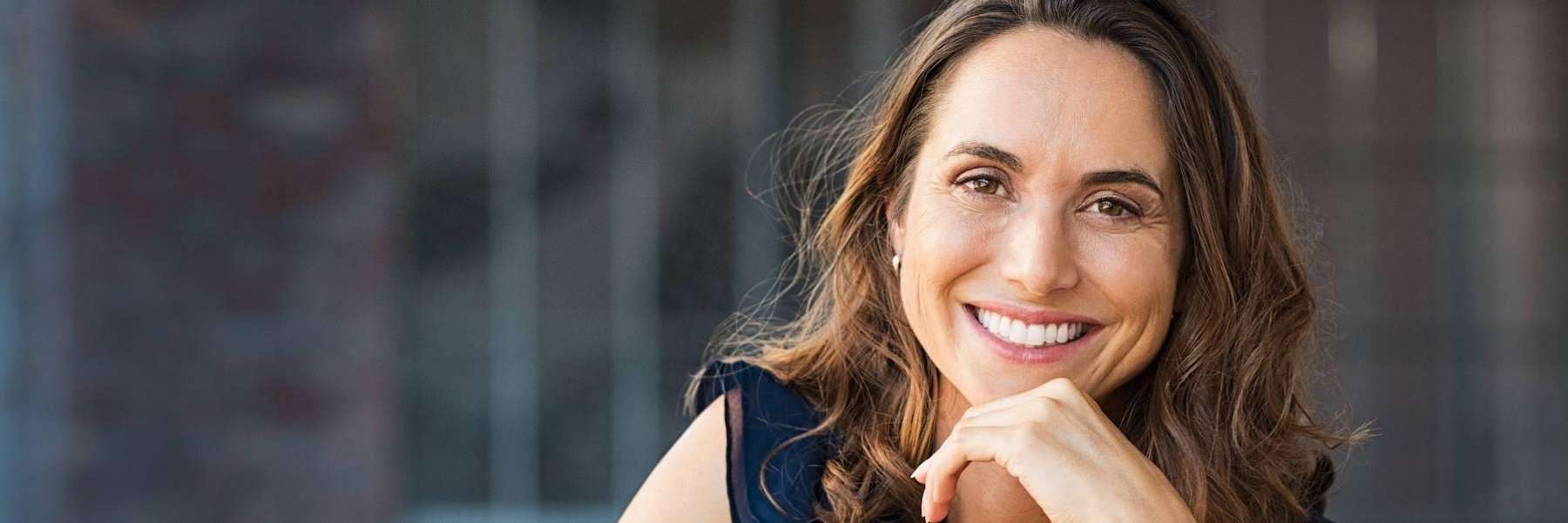 woman with brown hair smiling | veneers cookeville tn