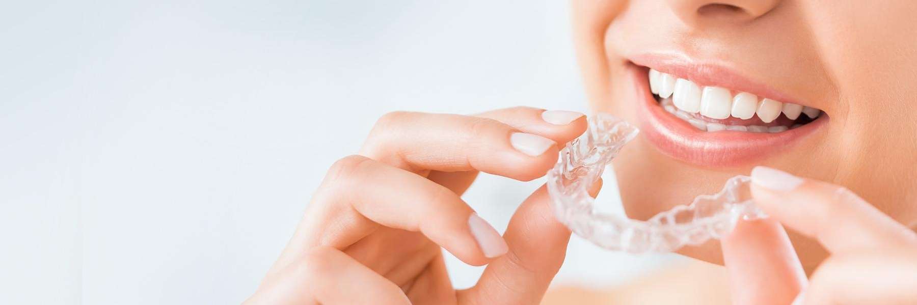 patient holding plastic clear aligner | cosmetic dentist cookeville tn