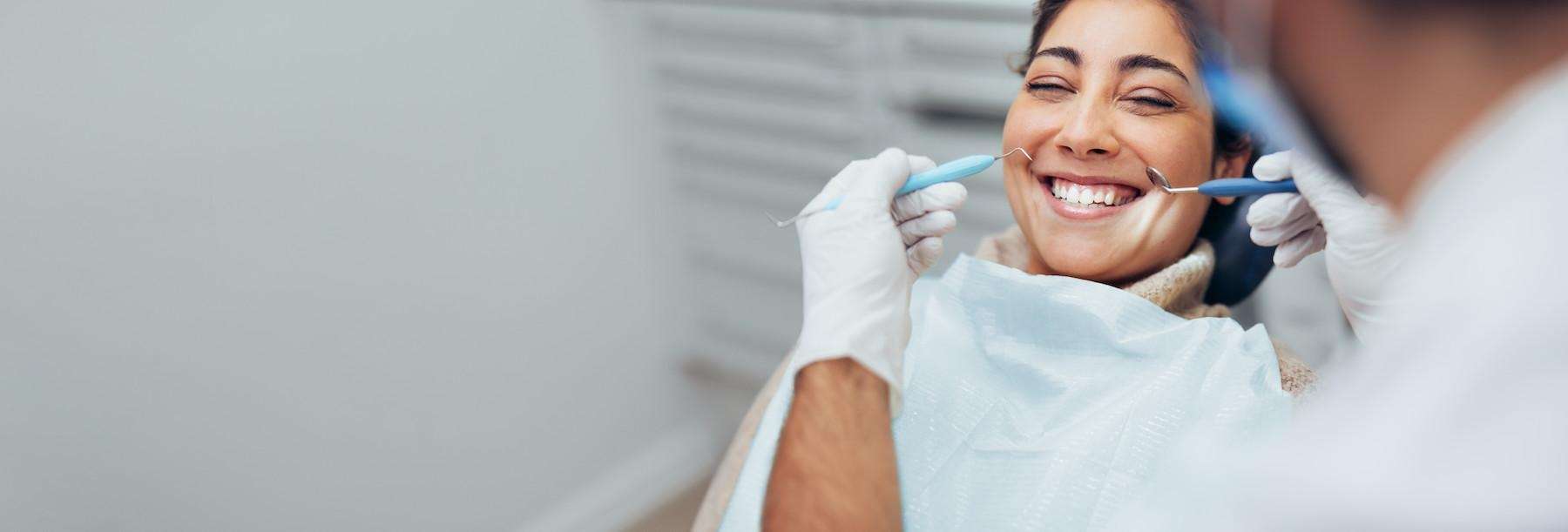 woman smiling in exam chair | root canal cookeville tn